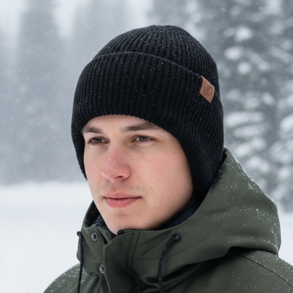 Mütze mit Ohrenklappen in Schwarz getragen im Schneetreiben